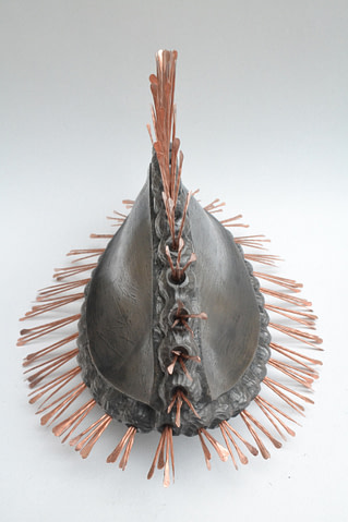 escultura hecha en cerámica inspirada en la semilla de un lirio